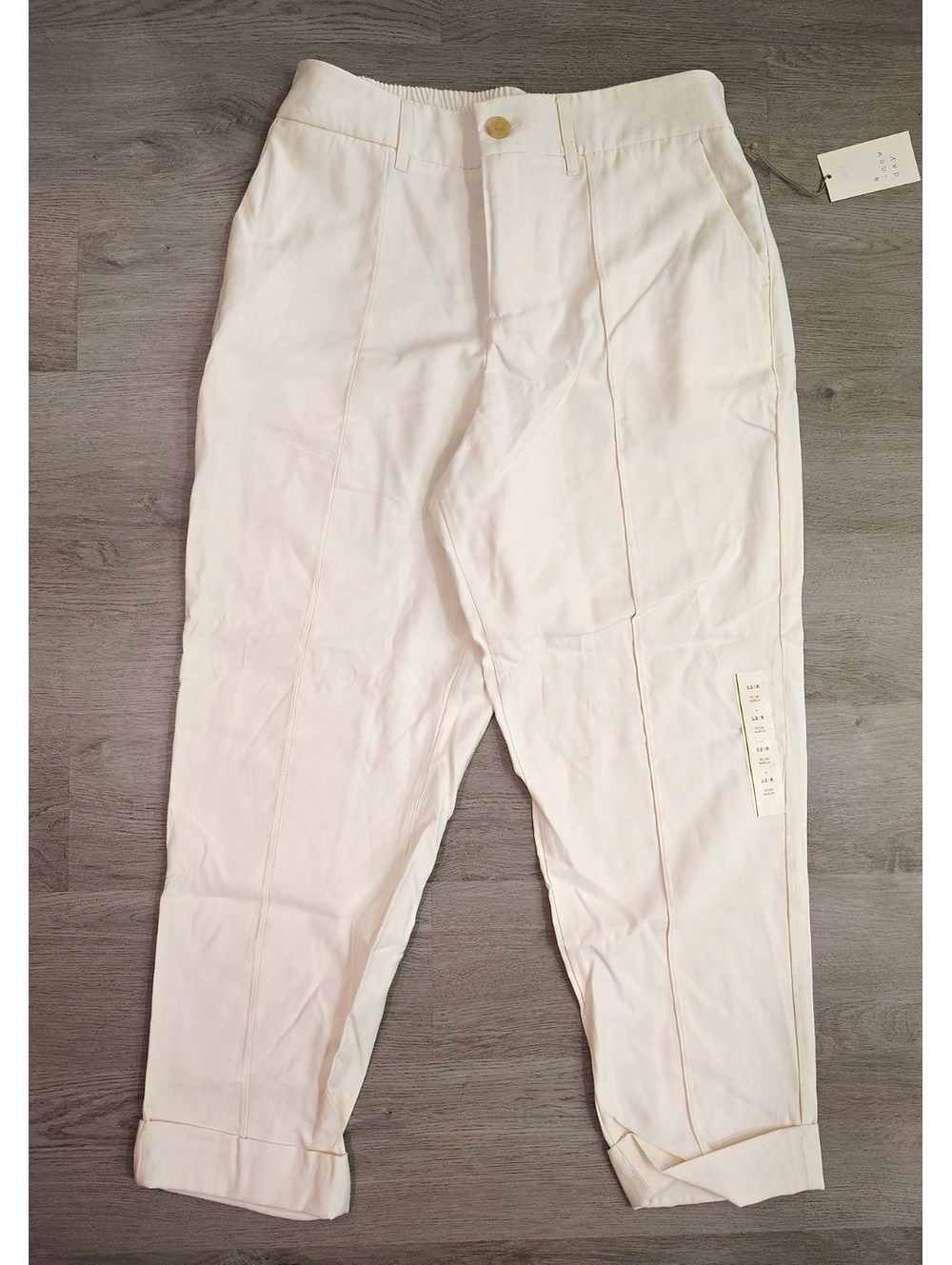 A New Day cream slim ankle pants with pockets elastic waist. Size 12.